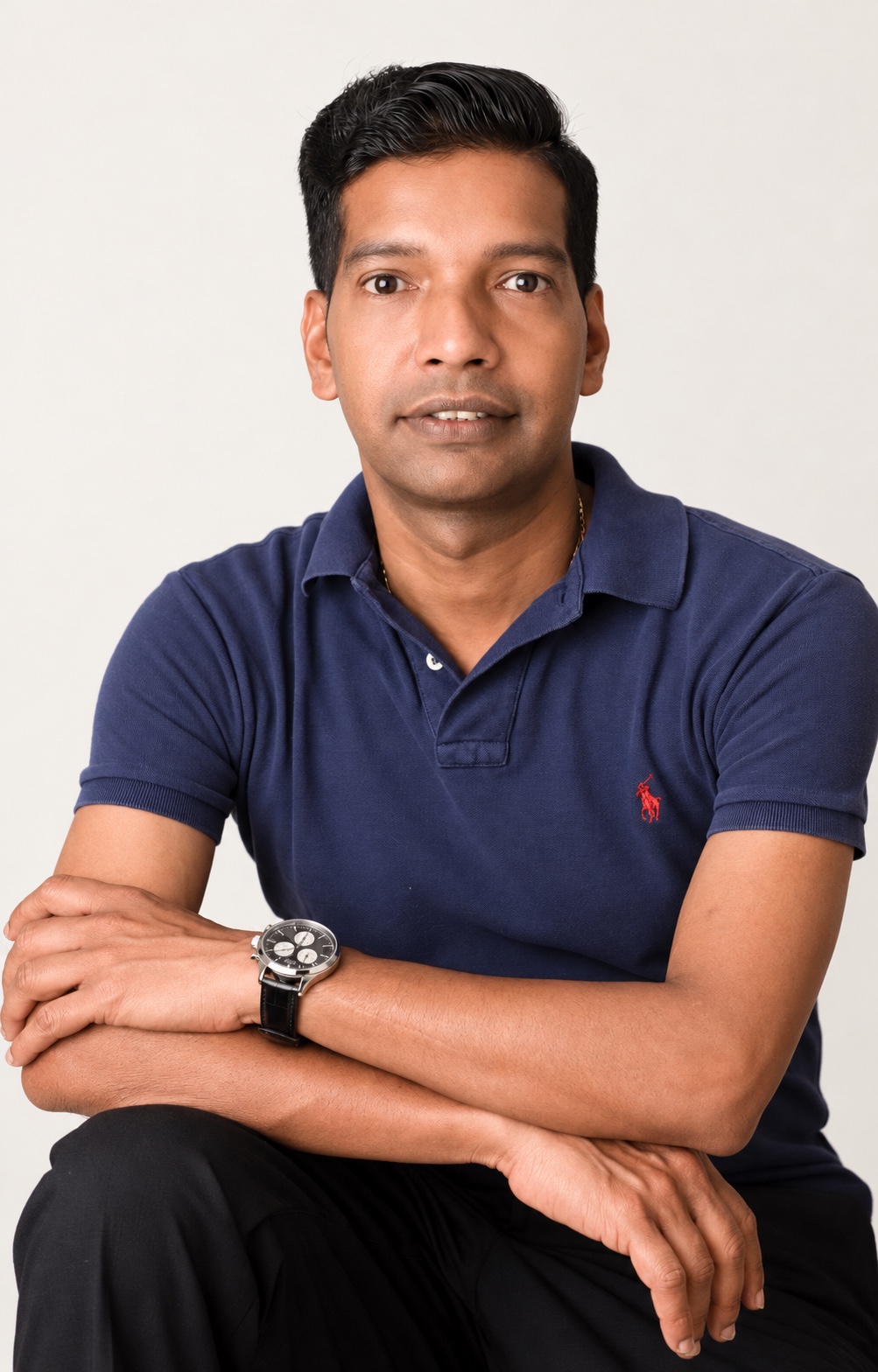 Portrait of Naga Kandiah wearing a navy polo shirt